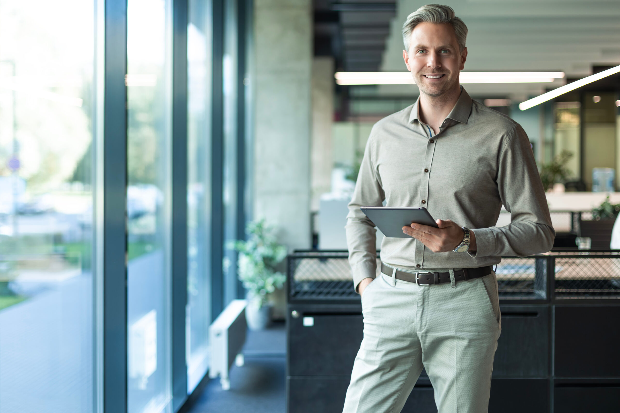 Man wearing a Drysolv shirt and trousers in an open-plan office